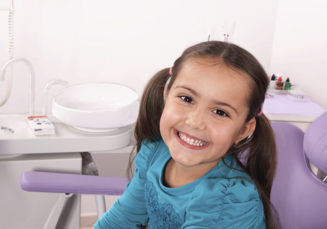 cute little girl in dental chair smiling