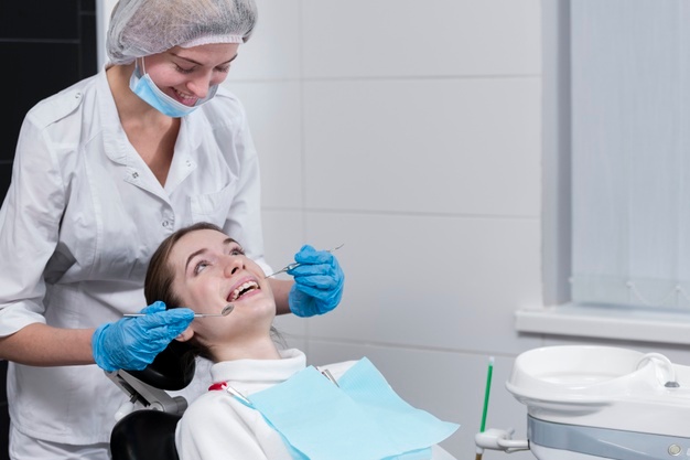 female dentist performing dental check patient 23 2148396183